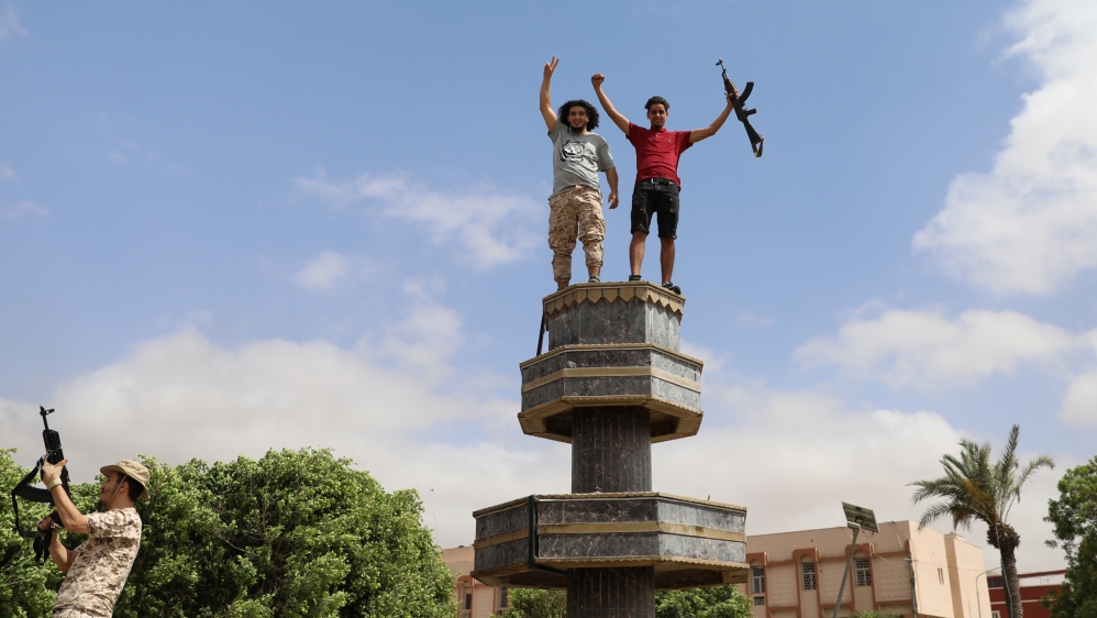 Fighters loyal to Libya''s internationally recognised government celebrate after regaining control over Tarhouna city