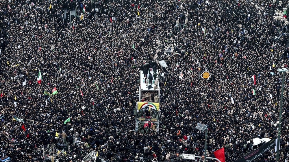 Coffins of Gen. Qassem Soleimani and others who were killed in Iraq by a U.S. drone strike, are carried on a truck surrounded by mourners during a funeral procession, in the city of Mashhad, Iran, Sun