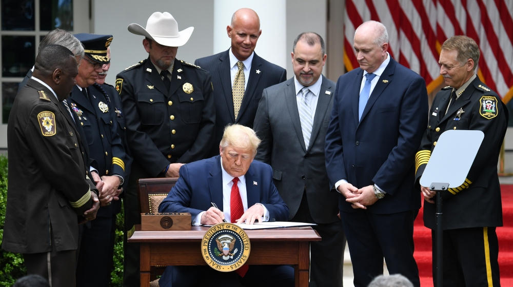 US President Donald Trump signs an Executive Order on Safe Policing for Safe Communities, in the Rose Garden of the White House in Washington, DC, June 16, 2020. SAUL LOEB / AFP