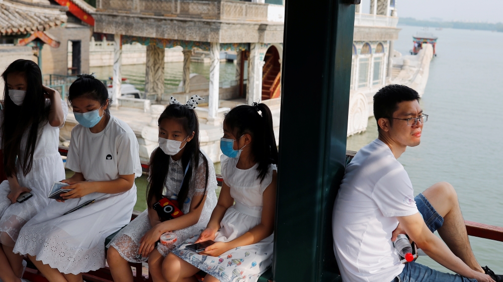 People relax in the park at Summer Palace on a public holiday, after a new outbreak of the coronavirus disease (COVID-19), in Beijing