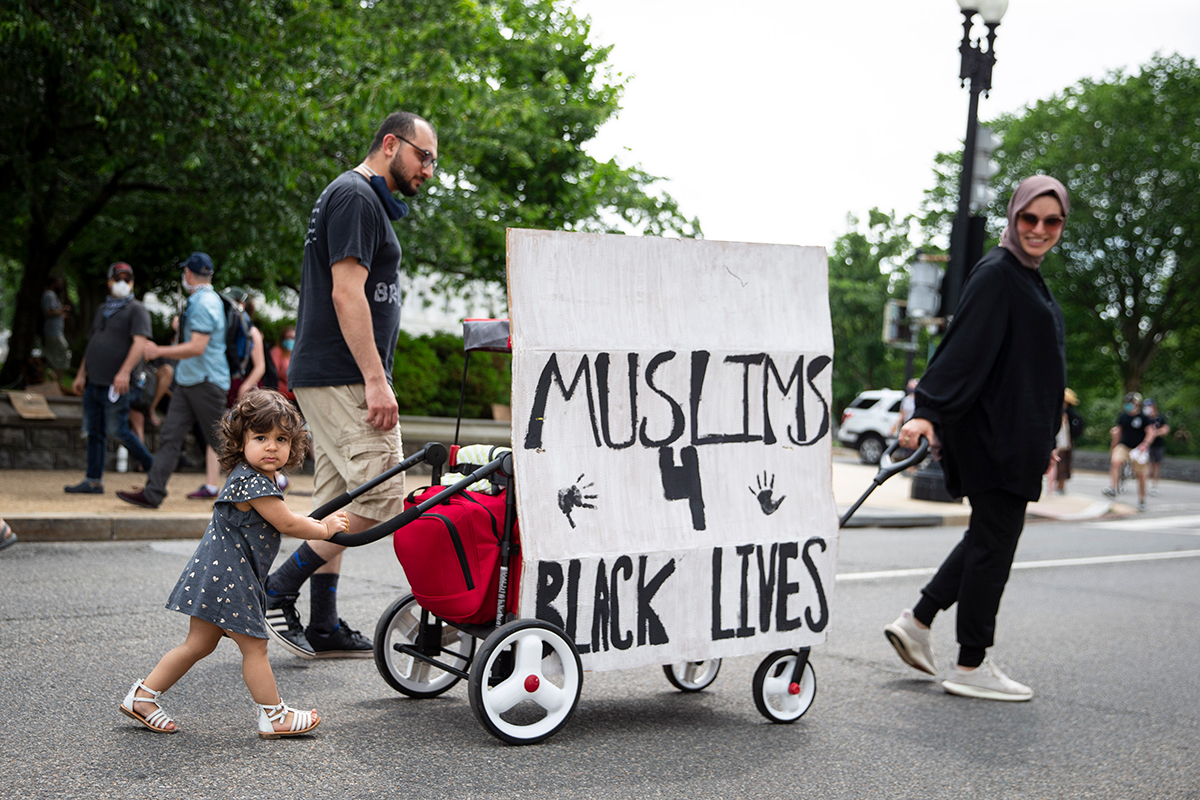 epa08470030 A family walks with protesters along Constitution Avenue near the US Capitol, towards the White House where there has been a week of protests over the death of George Floyd, who died in po