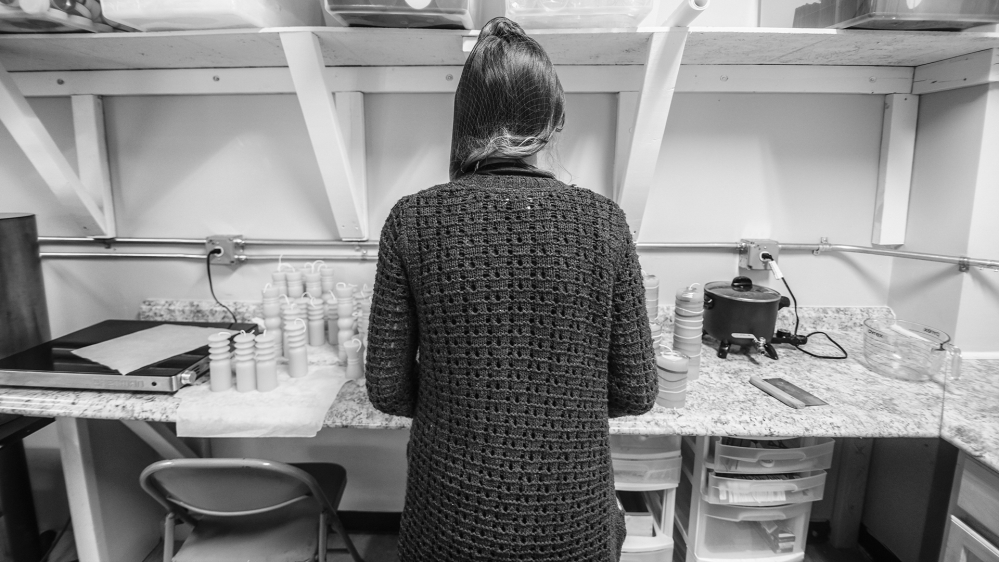 A human trafficking survivor makes candles at the Well community centre in Baltimore