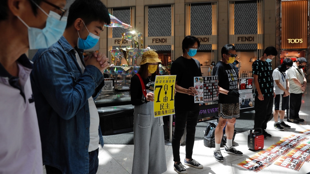Pro-democracy protesters observe a minute of silence during a protest after China's parliament passes a national security law for Hong Kong