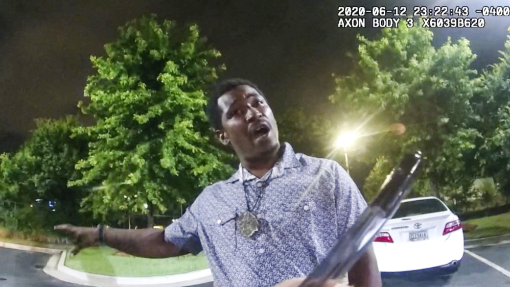 A screen grab taken from body camera video provided by the Atlanta Police Department shows Rayshard Brooks speaking to Officer Garrett Rolfe in the parking lot of a Wendy’s restaurant before he was killed [Atlanta Police Department via AP]