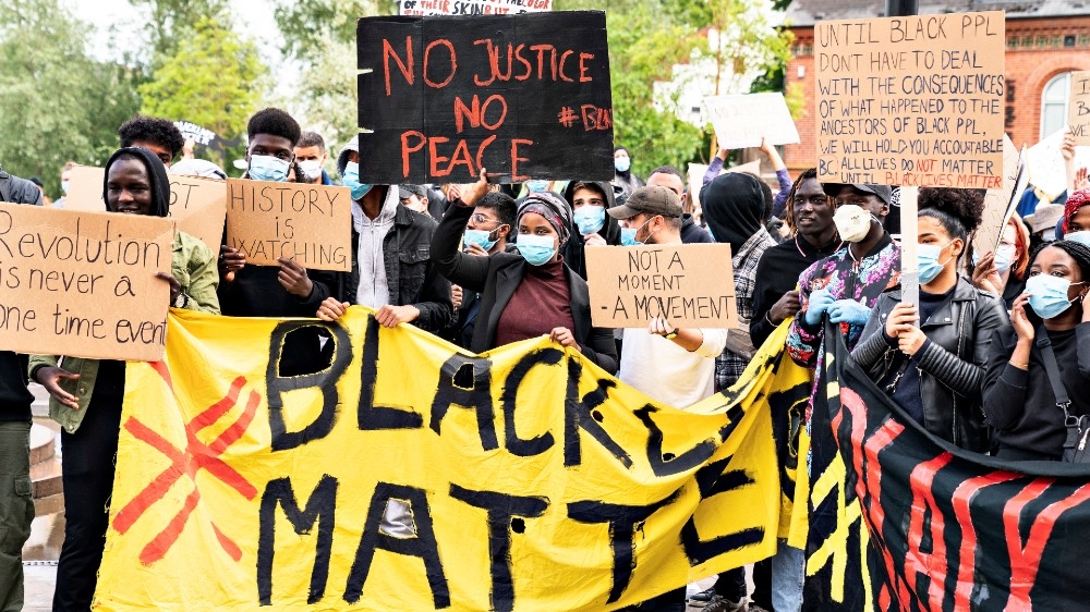 People take part in a demonstration to show solidarity with the Black Lives Matter movement, in Aalborg