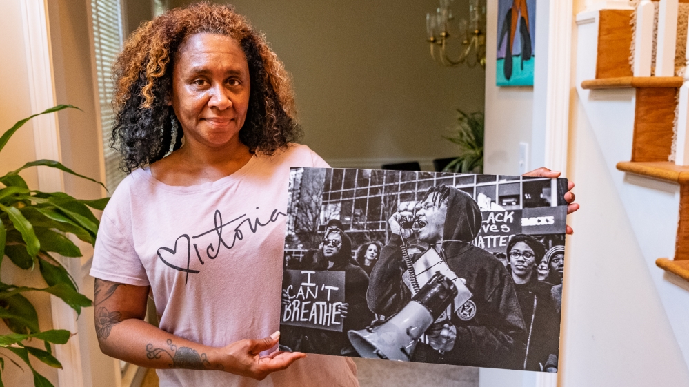 Jacqueline Sanders holds a picture of her son during protests against police brutality