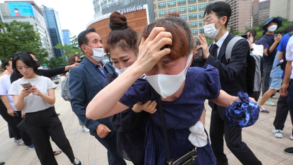 Mourners, many wearing masks, gather outside Seoul City Hall on Saturday to pay tribute to the late Seoul Mayor Park Won-soon amid the continuing spread of the coronavirus in the city