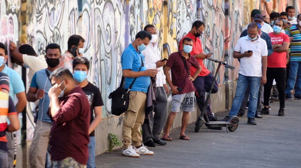 Members of the Bangladeshi immigrant community queue to undergo swabs to test for COVID-19 outside a healthcare centre in Rome on Thursday