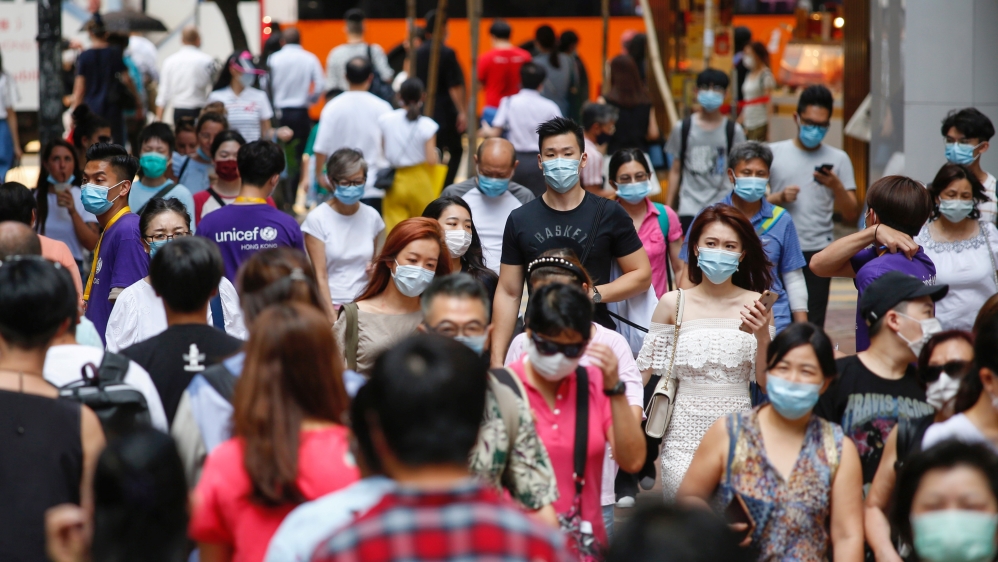 People wear surgical masks following the coronavirus disease (COVID-19) outbreak in Hong Kong