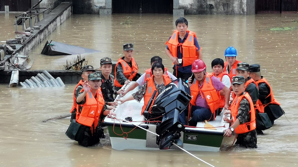 epa08531975 Rescuers evacuate people from flooded villages in Shexian county, Anhui province, China, 07 July 2020. Over 120 people have been killed in the current flood season in China.  EPA-EFE/LIAO 