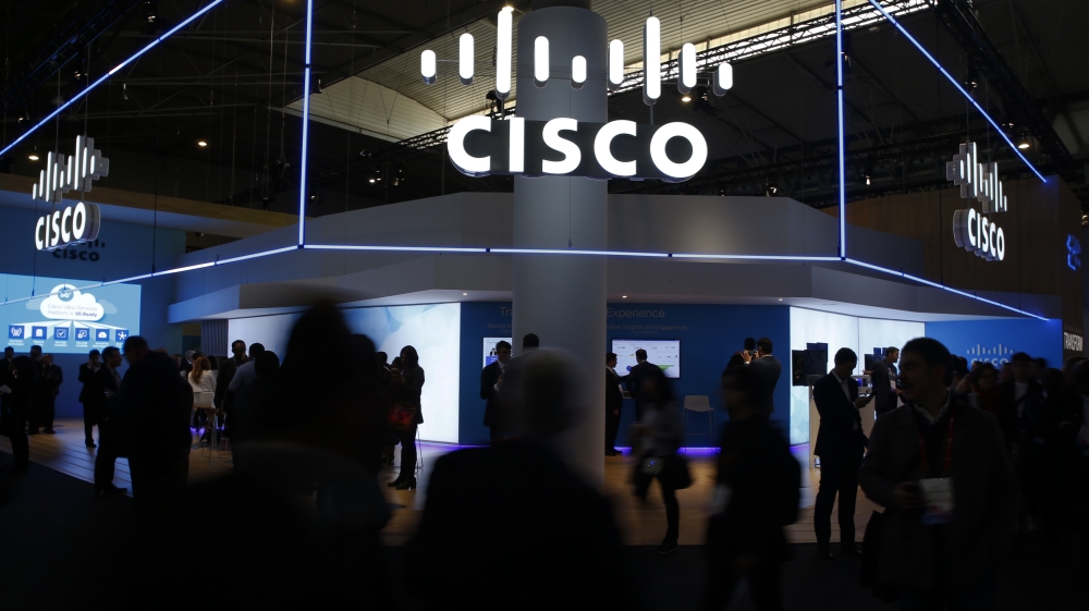 Visitors walk past Cisco''s booth during Mobile World Congress in Barcelona, Spain, February 27, 2017. REUTERS/Paul Hanna