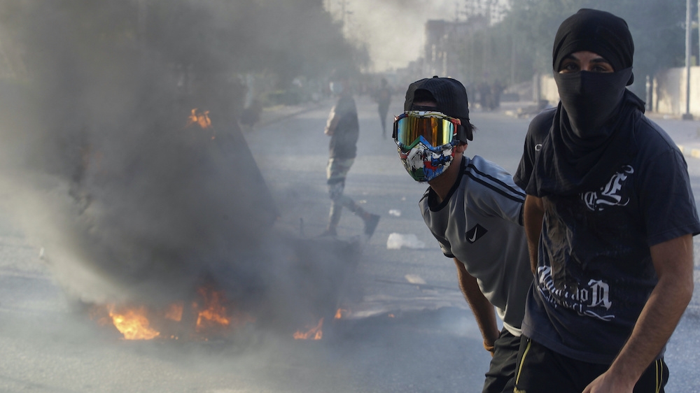 Iraqi demonstrators pose for a photo after burning objects to block the road during a protest in June. On Monday, the IMF warned that rising social unrest is a key risk as MENA economies struggle with the fallout from the coronavirus pandemic
