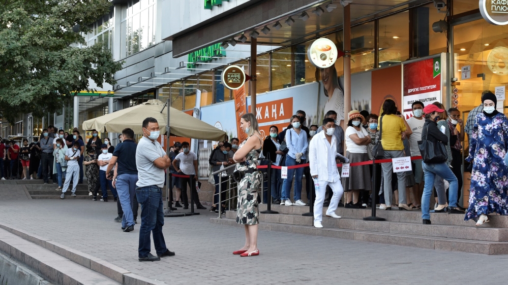 People queue outside a pharmacy in Almaty, Kazakhstan on June 29, 2020