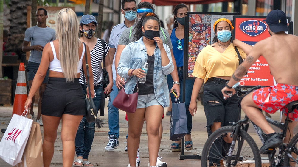 People walk through Lincoln Road in Miami Beach, Florida
