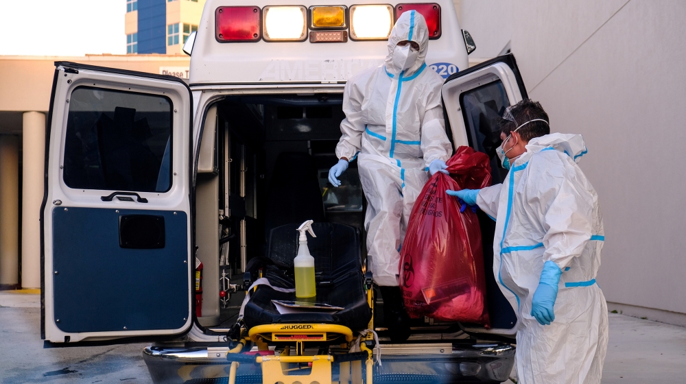 EMTs cleanse their materials outside Memorial West Hospital where coronavirus disease (COVID-19) patients are treated, in Pembroke Pines, Florida, U.S. July 13, 2020. REUTERS/Maria Alejandra Cardona