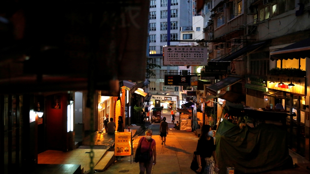 People wearing protective face masks walk at Mid-Levels Central, following the coronavirus disease (COVID-19) outbreak in Hong Kong