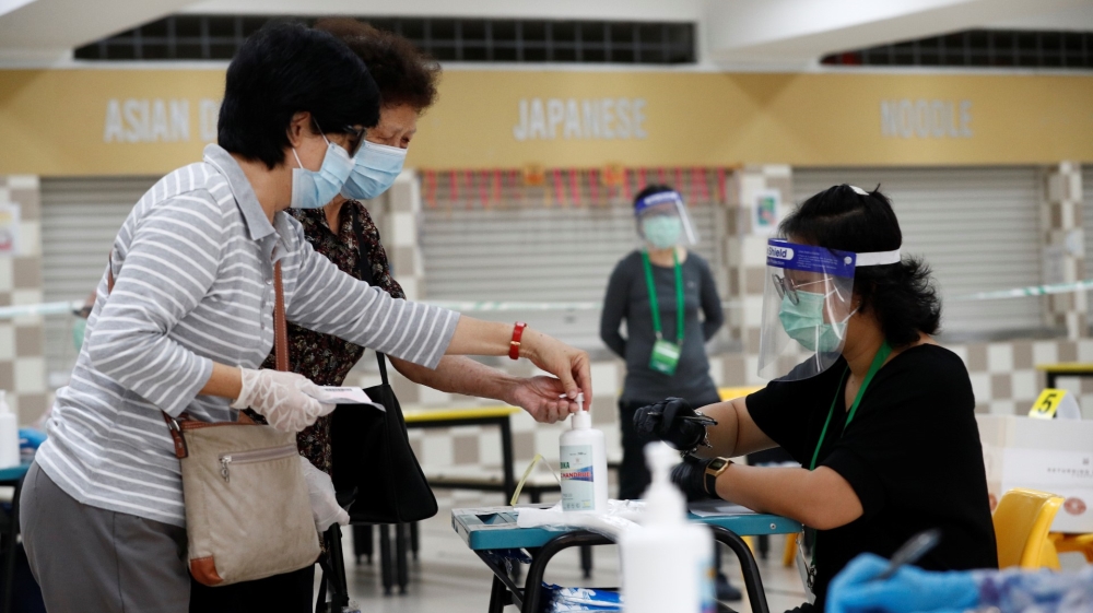 Voters sanitise their hands at a polling station during Singapore’s general election