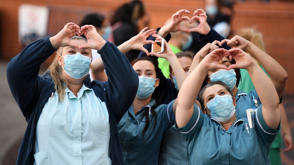 Staff at the Leeds General Infirmary participate in a national NHS celebration clap in Leeds on July 5, 2020