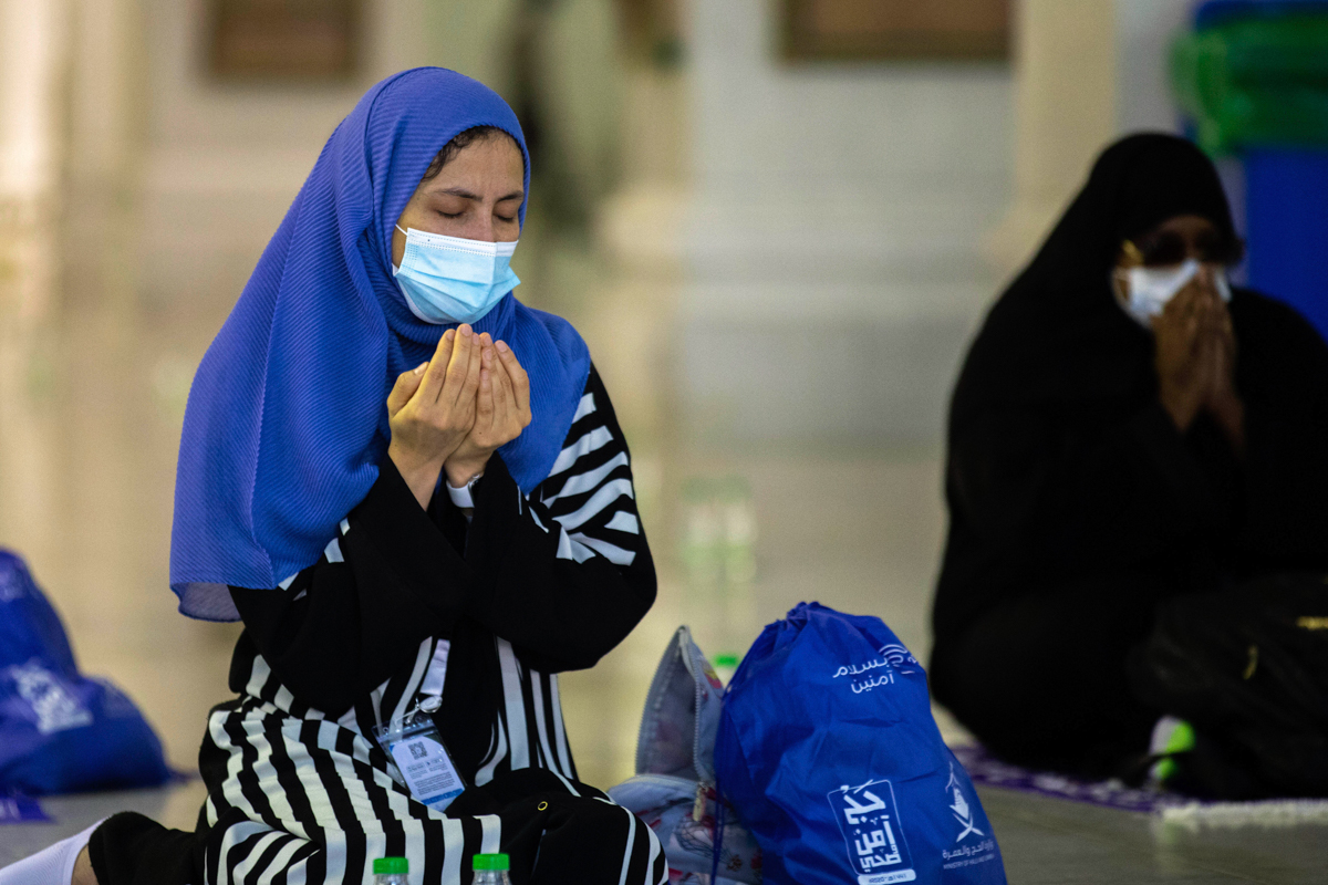 In this photo released by the Saudi Media Ministry, a limited numbers of pilgrims pray in the first rituals of the hajj, as they keep social distancing to limit exposure and the potential transmission