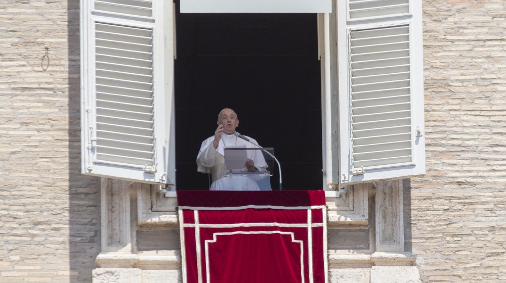 Pope Francis delivers his message after the Angelus noon blessing from the window of his studio overlooking St. Peter's Square at the Vatican, Sunday, July 12, 2020. In a very brief, improvised remark