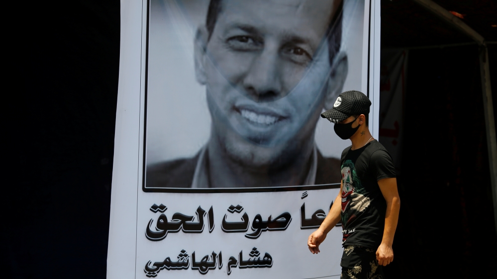 An Iraqi demonstrator wears a protective mask