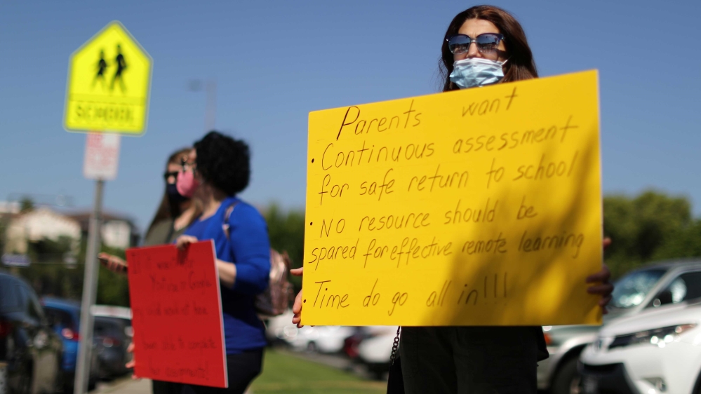 Parents hold signs to highlighting inadequacies in their children’s online education outside the Glendale Unified School District Headquarters, amid the outbreak of the coronavirus disease (COVID-19), in Glendale, California, US