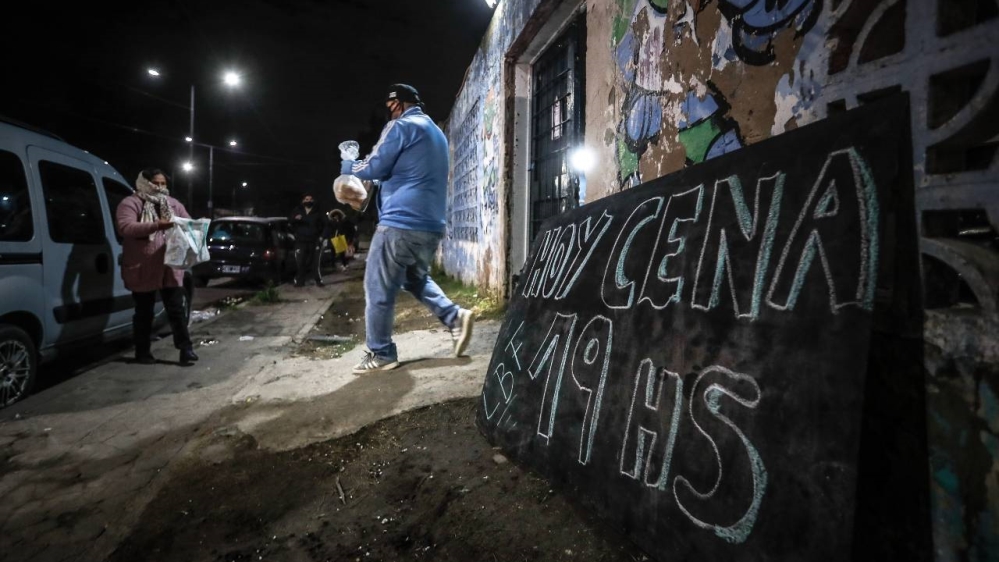 A woman receives food at a community centre in Buenos Aires amid the coronavirus pandemic