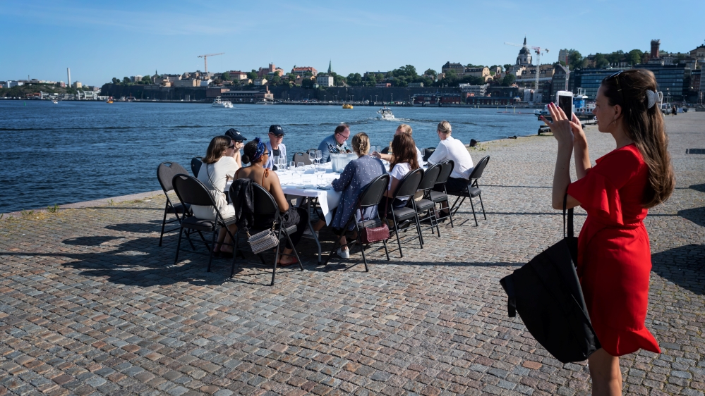 People have a drink after work while keeping a social distance due to the outbreak of the coronavirus disease (COVID-19), in Stockholm, Sweden