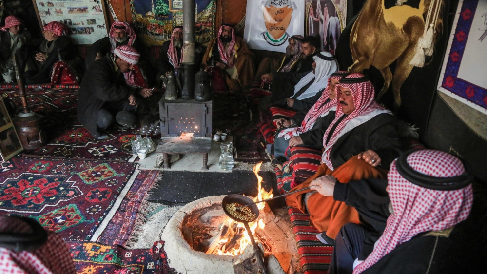 Syrian Bedouins roast coffee beans in a camp during a gathering of tribesmen near the town of Hamouria, in the eastern Ghouta region on the outskirts