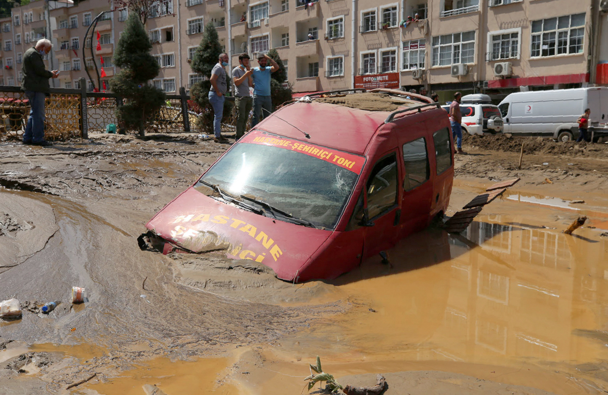 People inspect the destruction after floods caused by heavy rain in the mountain town of Dereli in Giresun province, along Turkey''s Black Sea coastline, Sunday, Aug. 23, 2020. Interior Minister Suley