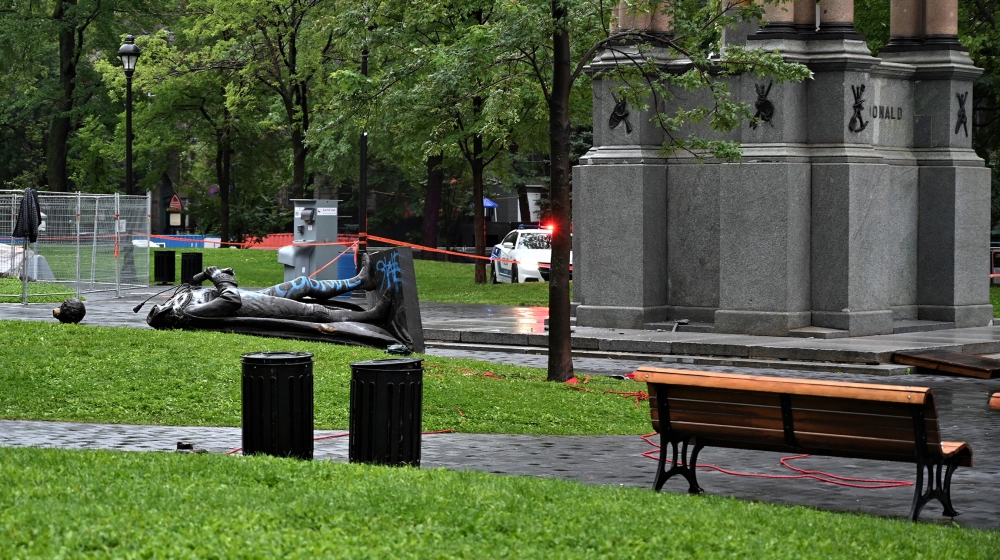 A statue of the first Canadian Prime Minister John A. Macdonald lies on the ground, with the statue''s head a few meters away, at Canada Park in central Montreal on August 29, 2020, after it was pulled
