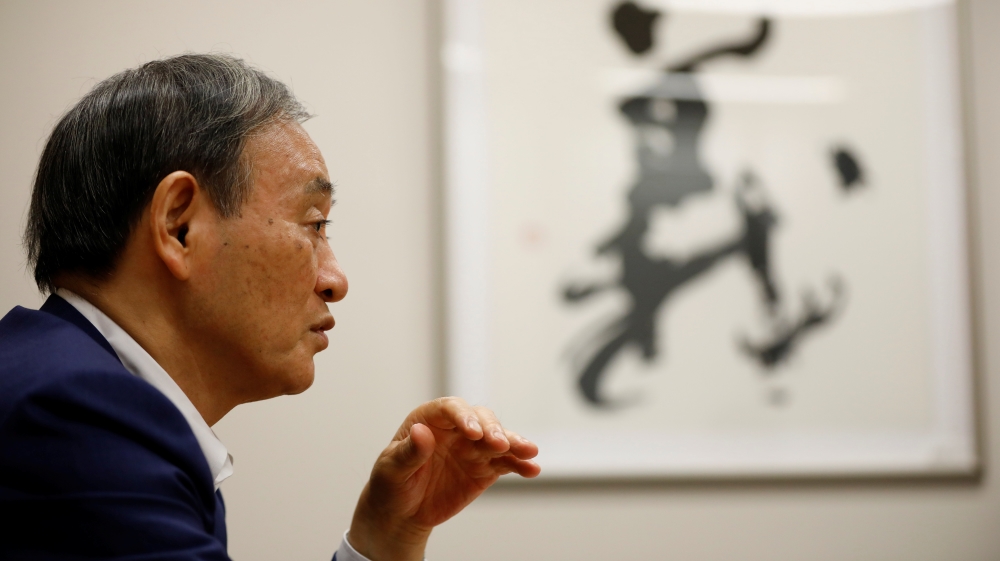 Japan's top government spokesman Chief Cabinet Secretary Yoshihide Suga speaks during an interview with Reuters in Tokyo