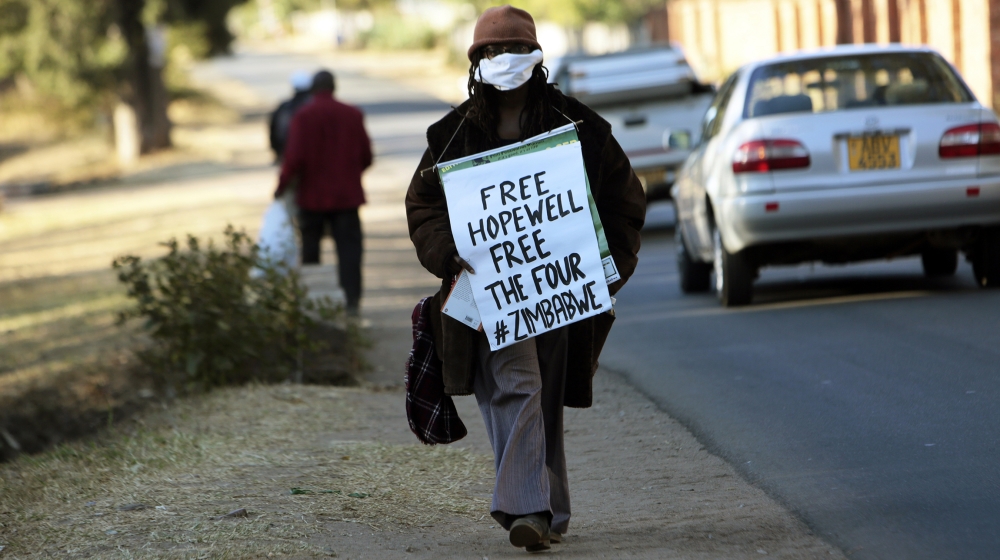 Zimbabwean writer and filmaker Tsitsi Dangarembwa demonstrates outside Hopwell Chin''onos house in Harare, Monday, July 20, 2020. Lawyers say Zimbabwe police have swooped in and detained a prominent j