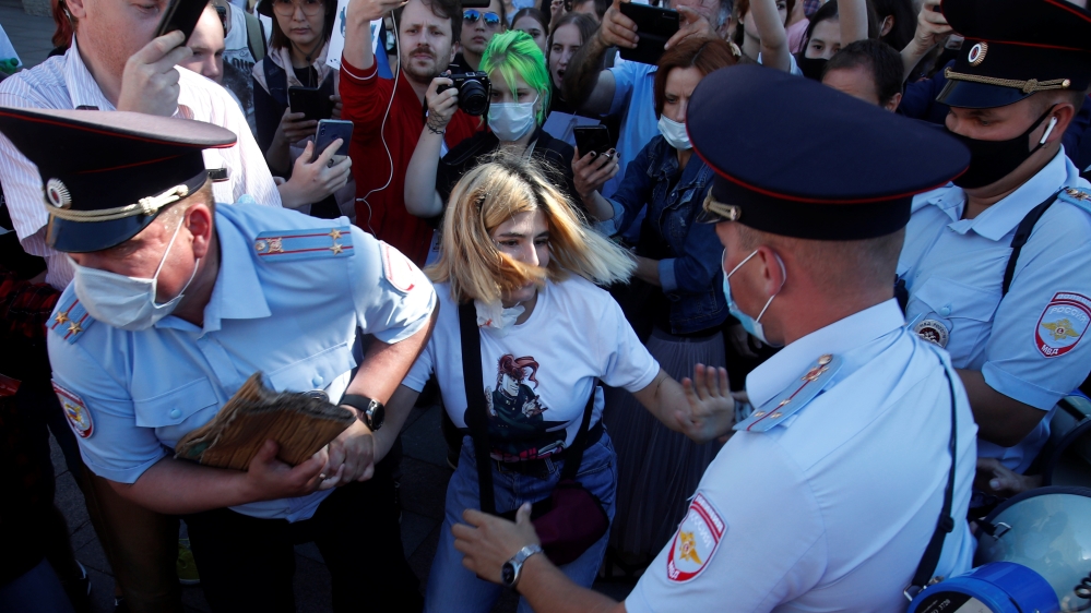 Police officers detain a demonstrator during an anti-Kremlin rally in Saint Petersburg