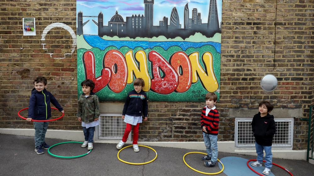 Children use hoops for social distancing at L'Ecole Des Petits school