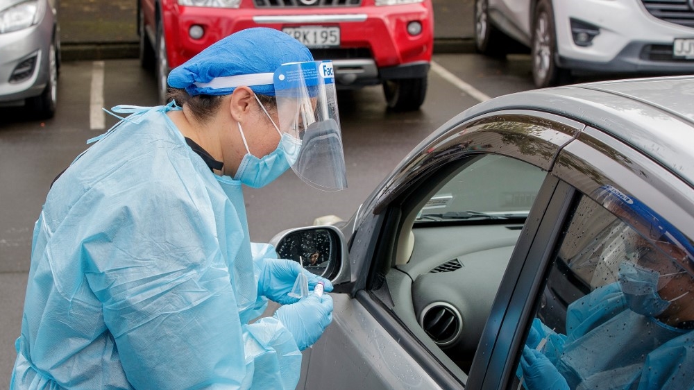 A health worker conducts a test at a COVID-19 coronavirus testing centre in the suburb of Northcote in Auckland on August 12, 2020