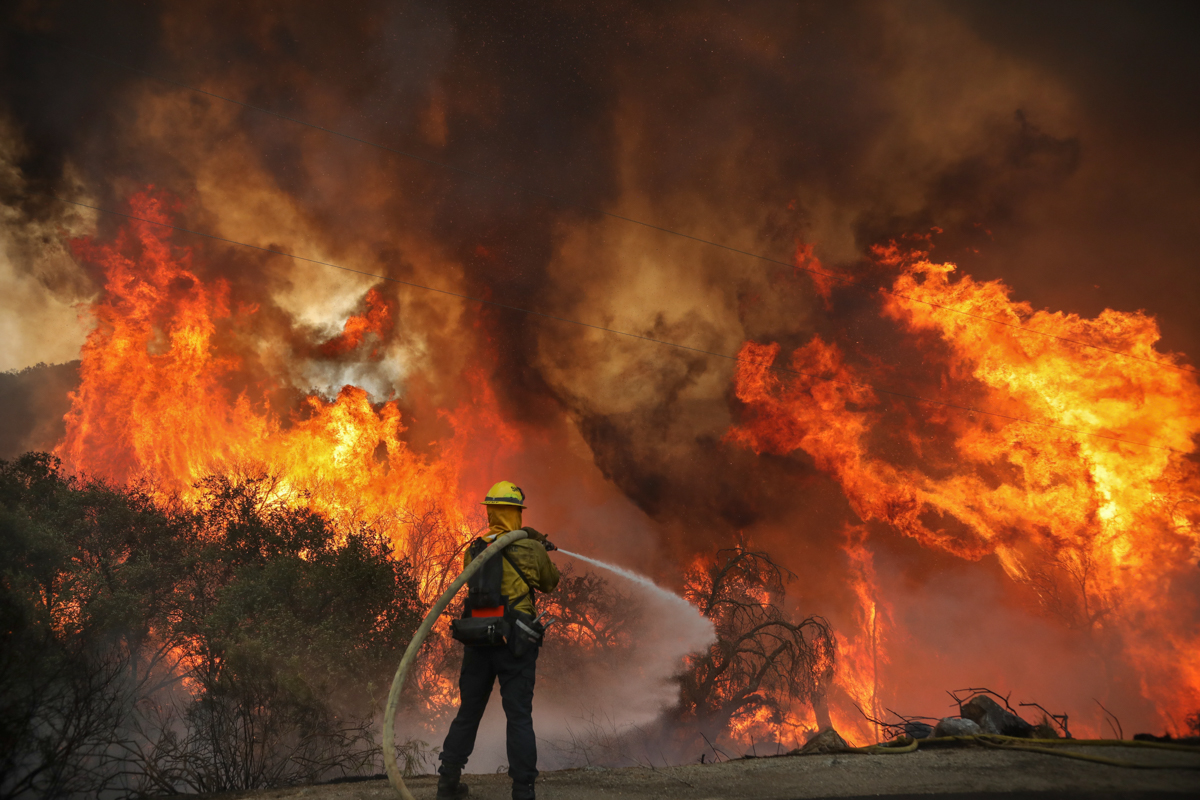 San Miguel County Firefighters battle a brush fire along Japatul Road during the Valley Fire in Jamul, California on September 6, 2020 - The Valley Fire in the Japatul Valley burned 4,000 acres overni