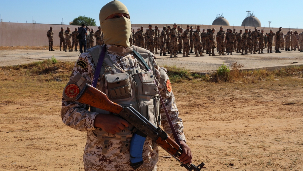 Members of the Petroleum Facilities Guard are seen at the Azzawiya oil refinery, in Zawiyah, west of Tripoli