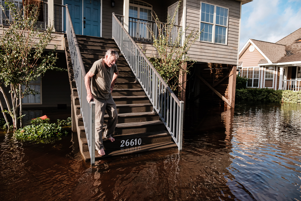 epa08674578 Larry Worley look at the base of his home flooded due to Hurricane Sally in Orange Beach, Alabama, USA, 16 September 2020. Hurricane Sally made landfall this morning as a Category 2 hurric