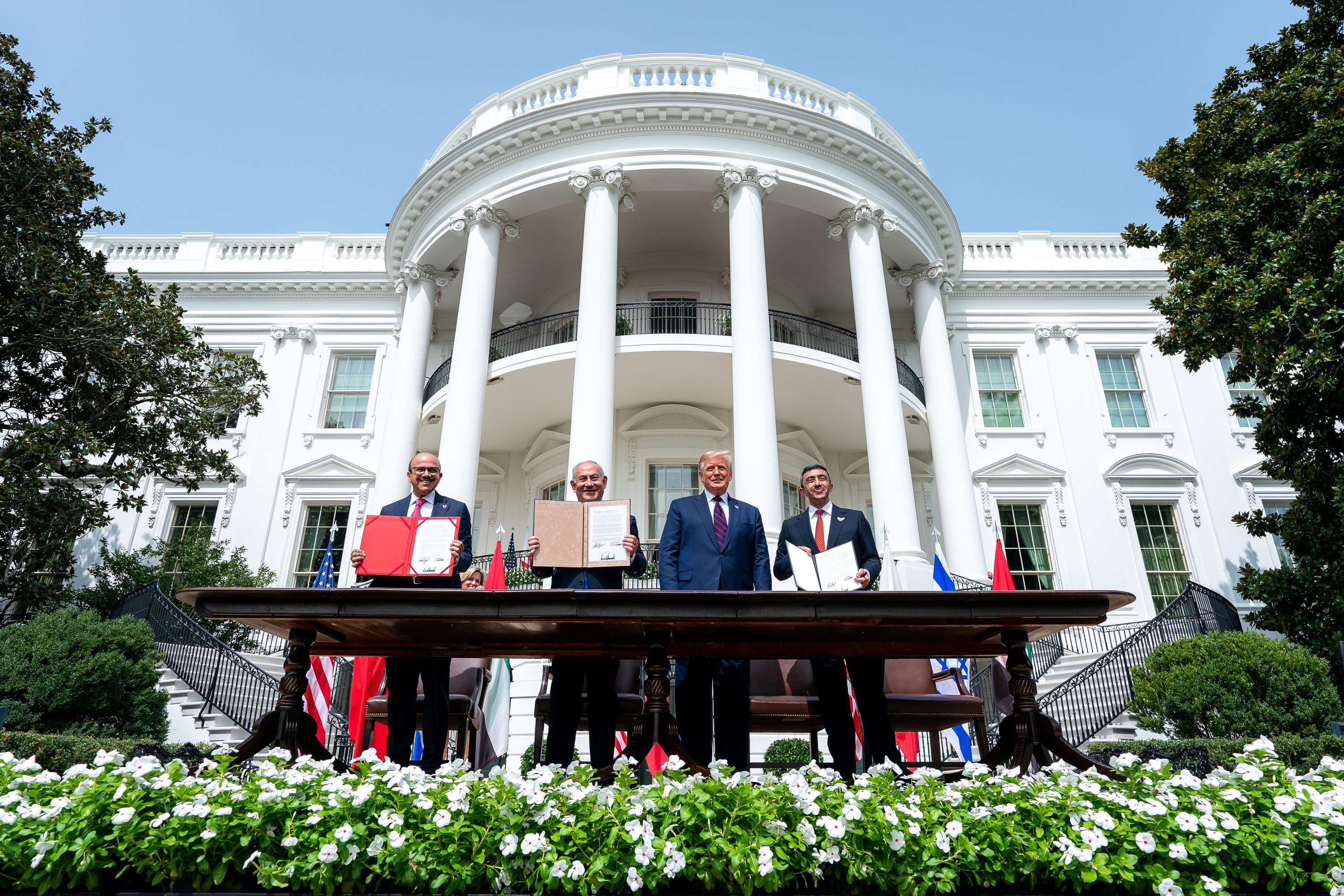 US President Donald Trump, Israeli Prime Minister Benjamin Netanyahu, UAE Foreign Minister Abdullah bin Zayed Al Nahyan and Bahrain Foreign Minister Abdullatif bin Rashid Al Zayani attend a signing ceremony for the agreements on "normalisation of relations" reached between Israel, the UAE and Bahrain at the White House in Washington, United States on September 15, 2020. [The White House / Tia Dufour / Handout via Getty Images]