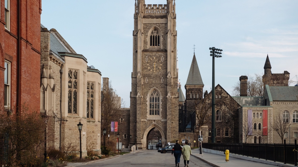 Pedestrians walk through the University of Toronto campus in Toronto, Ontario, Canada, on Tuesday, April 28, 2020. It could be August before Ontario''s economy is fully back in business after the coron