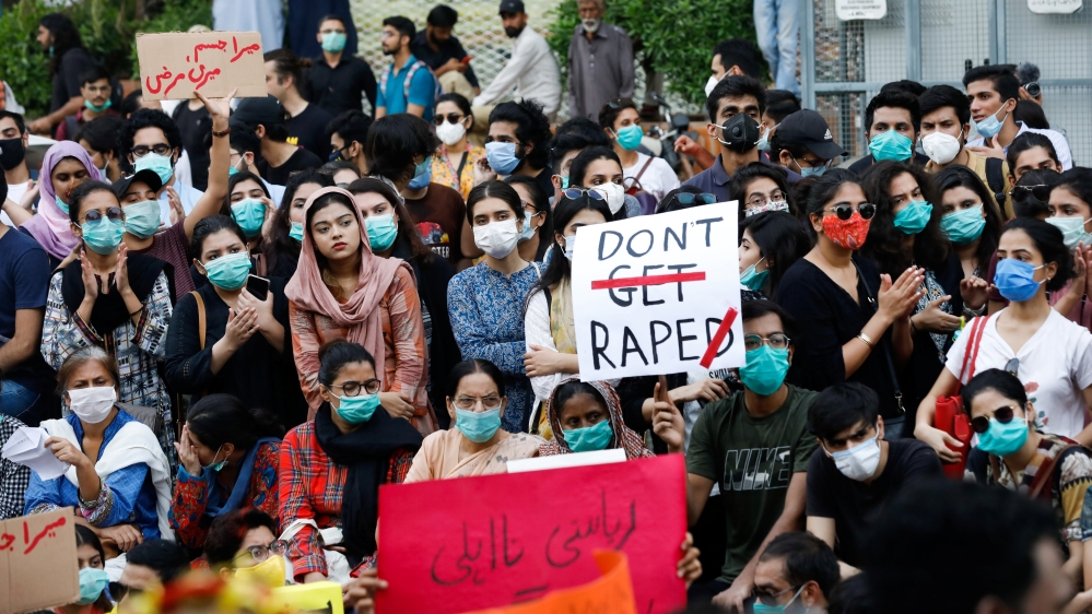 People carry signs to condemn violence against women and girls, during a protest in Karachi,