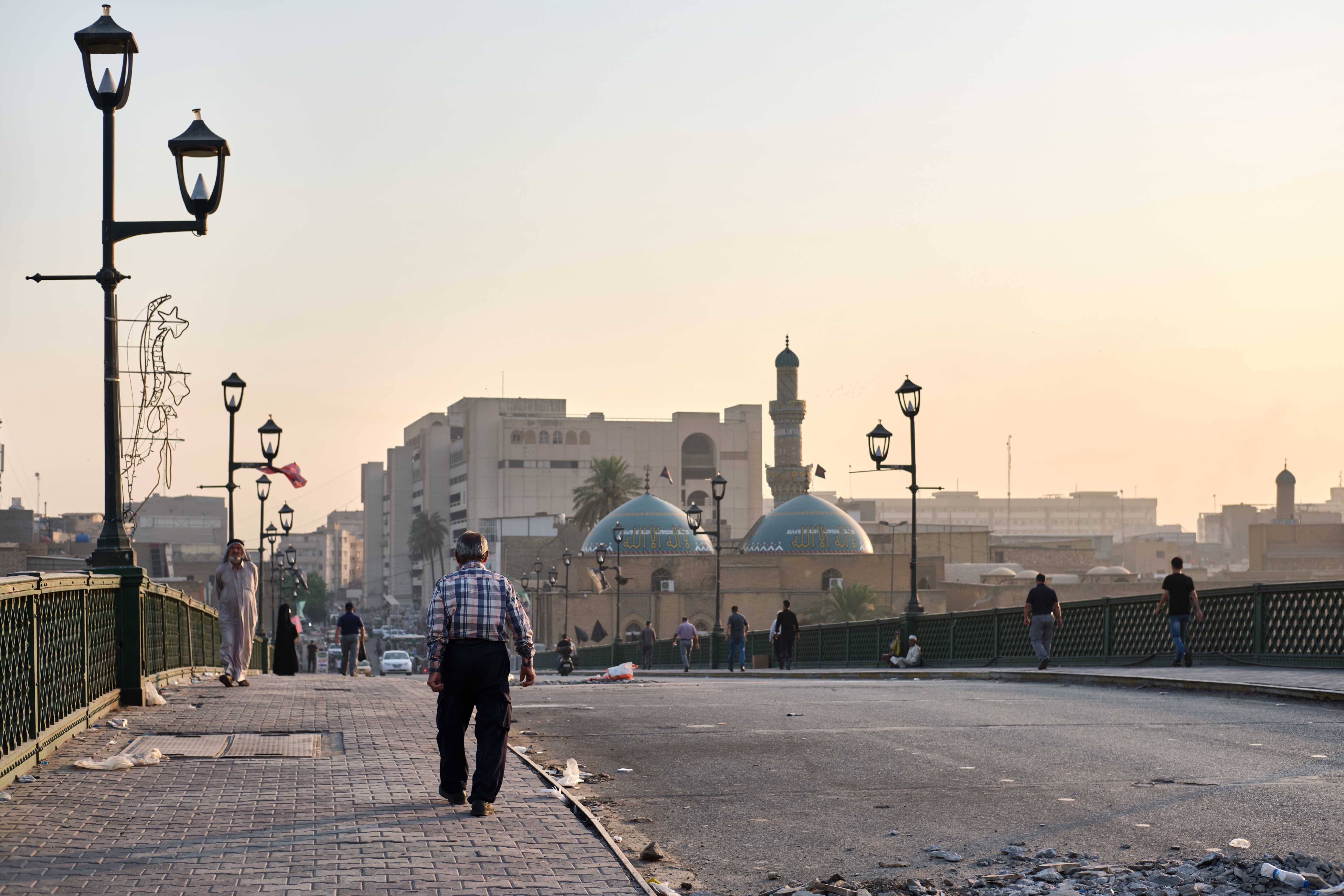 People walk across al-Shuhada bridge in Baghdad, Iraq on September 7, 2020. [Nabil Salih/Al Jazeera]