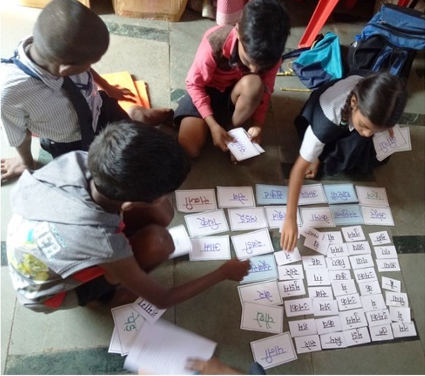 Students study cards in class [Photo courtesy of the Door Step School]