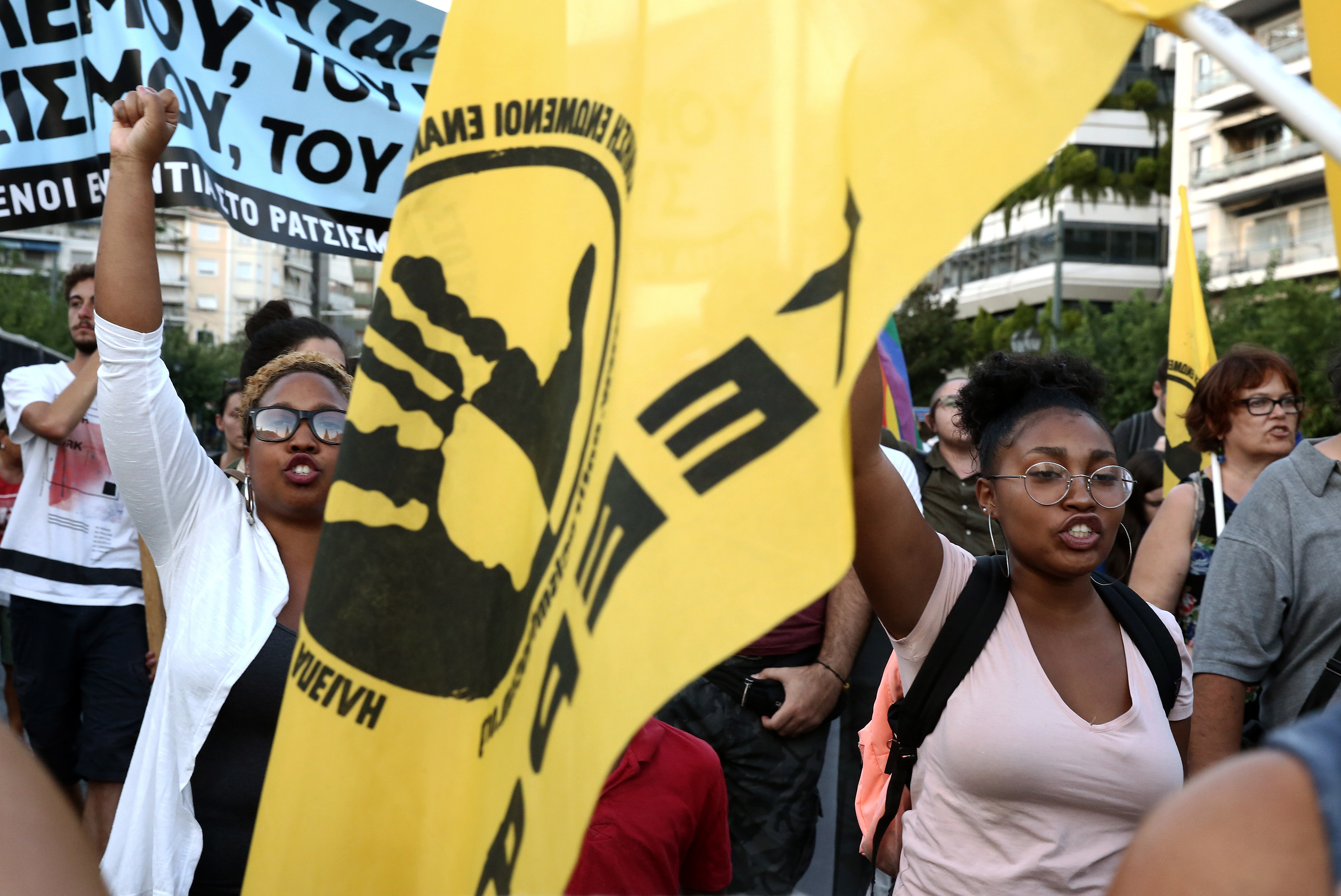 Demonstrators shout slogans during a protest march against racism and to honour Heather Heyer in front of the US embassy in Athens, Greece, 17 August 2017. Heather Heyer was killed as she protested racism in Charlottesville, US, on August 12 [Simela Pantzartzi/EPA]