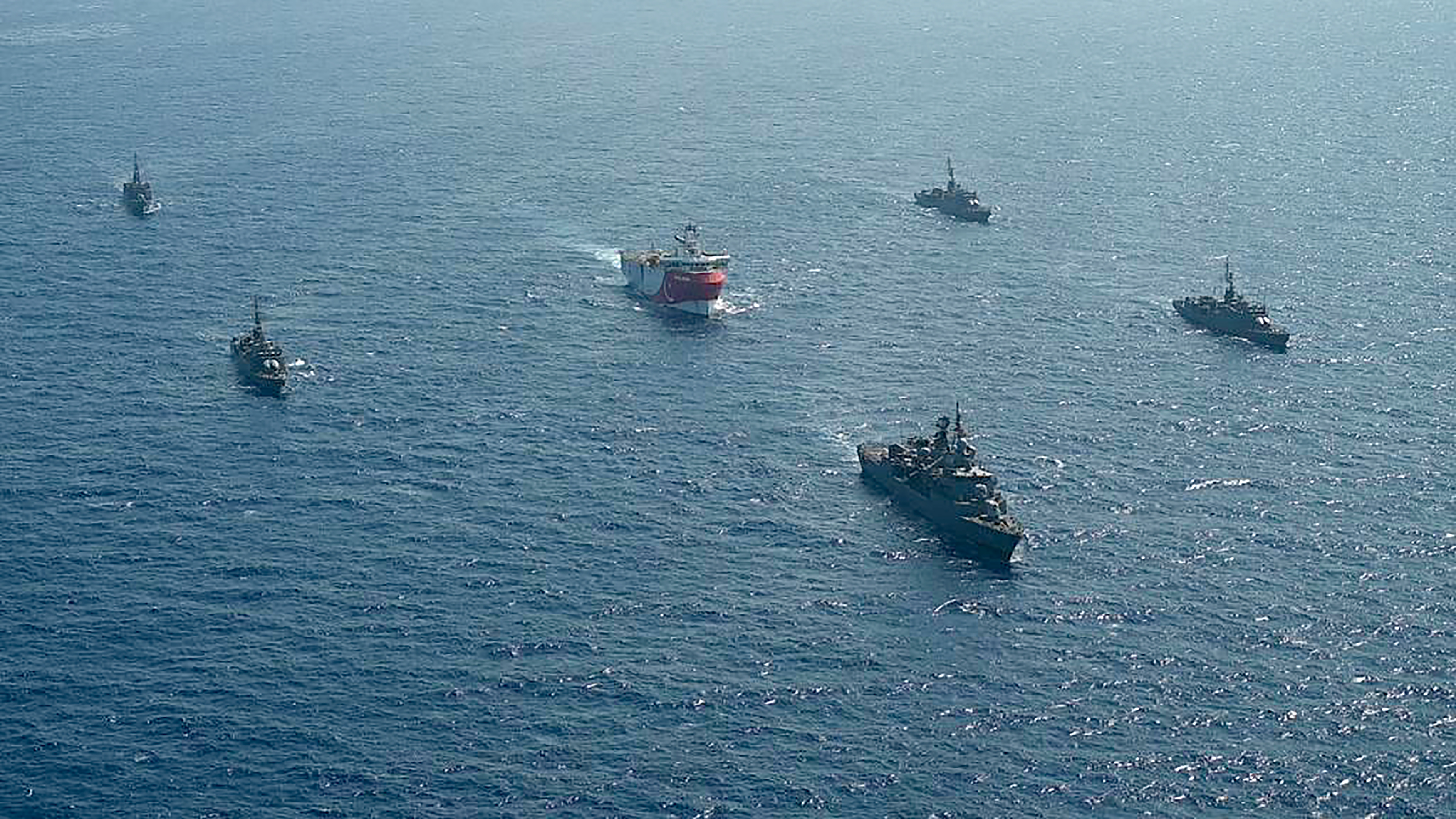 This handout photograph released by the Turkish Defence Ministry on August 12, 2020, shows Turkish seismic research vessel 'Oruc Reis' (C) as it is escorted by Turkish Naval ships in the Mediterranean Sea, off Antalya on August 10, 2020. - Greece on August 11, demanded that Turkey withdraw a research ship at the heart of their growing dispute over maritime rights and warned it would defend its sovereignty, calling for an emergency meeting of EU foreign ministers to resolve the crisis. Tensions were stoked August 10, when Ankara dispatched the research ship Oruc Reis accompanied by Turkish naval vessels off the Greek island of Kastellorizo in the eastern Mediterranean.