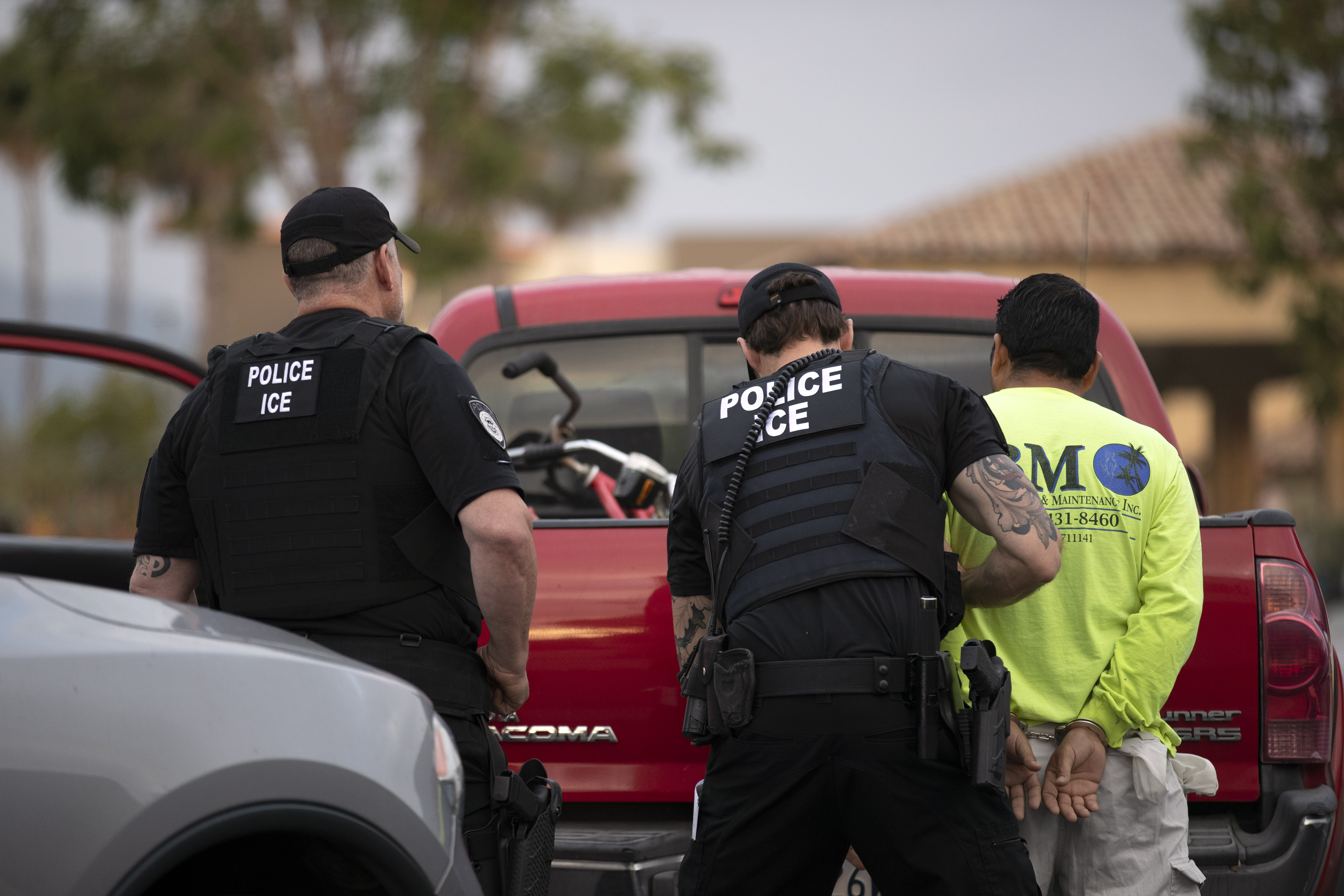 US Immigration and Customs Enforcement (ICE) officers detain a man during an operation in Escondido, California on July 8, 2019 [File: AP/Gregory Bull]