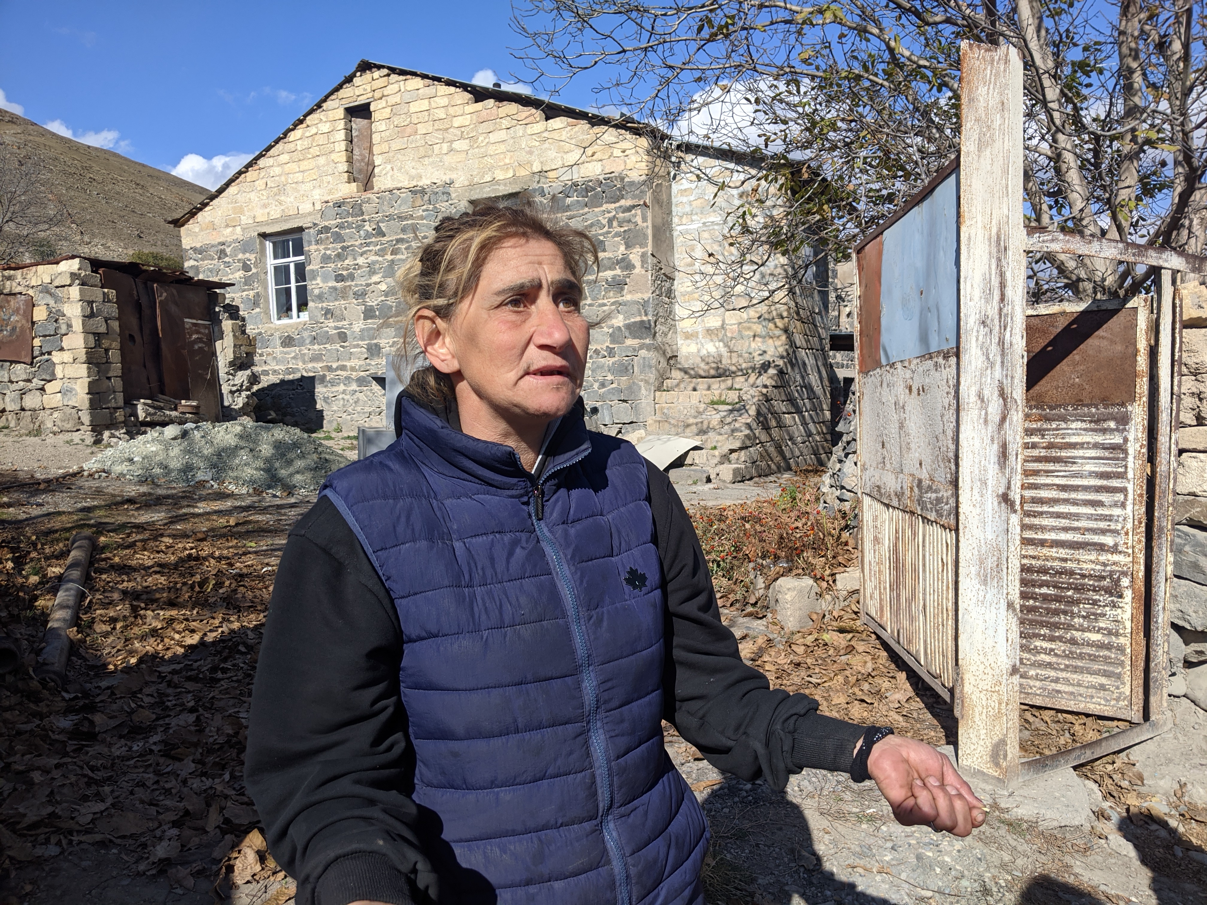 Karine Chakhelyan, outside her home in Kelbajar, says she feels she is being driven out 'like cattle' [Neil Hauer/Al Jazeera]