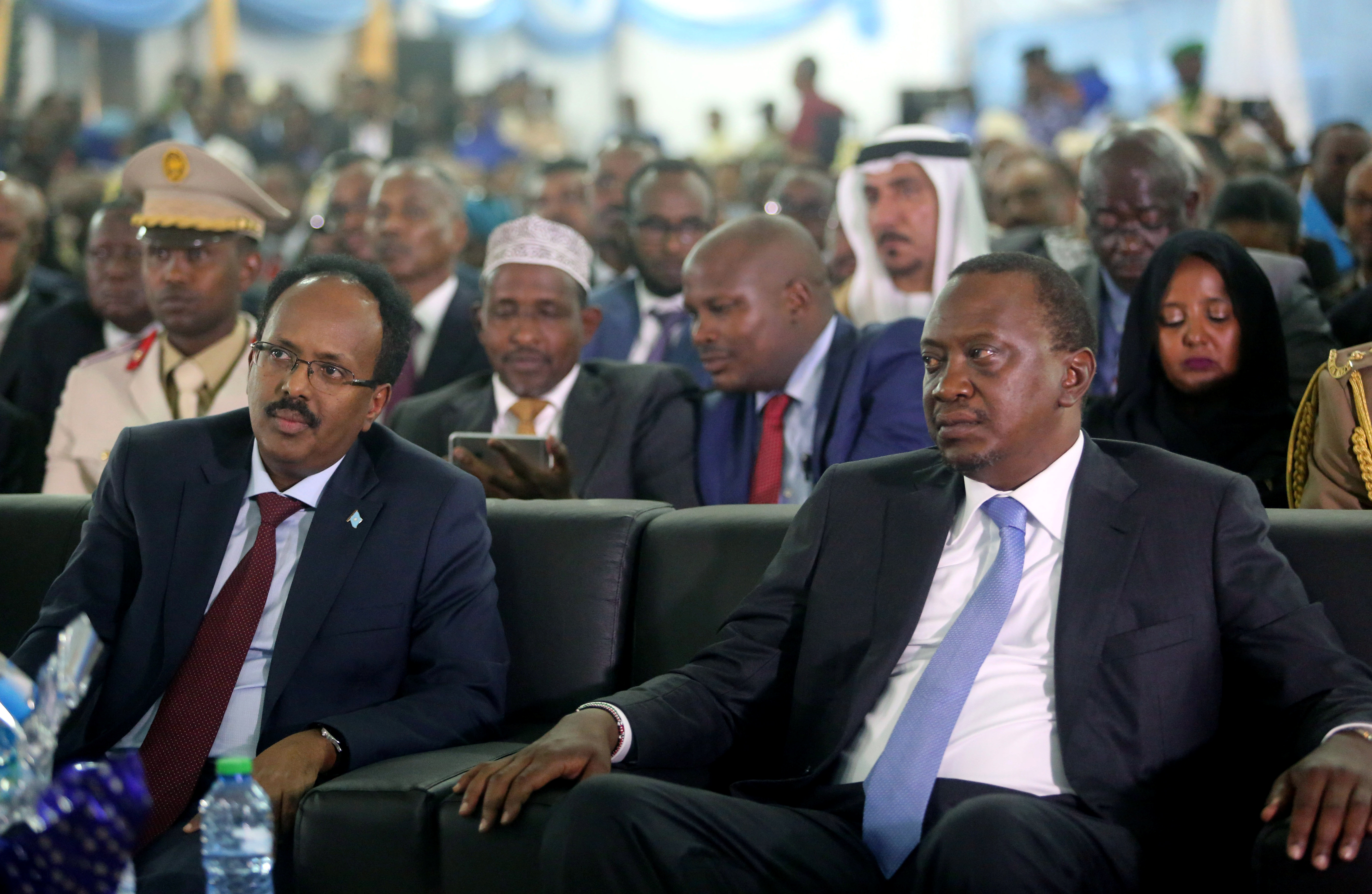 Somalia's President Mohamed Abdullahi Farmaajo and Kenya's President Uhuru Kenyatta listen to speeches during Farmaajo's inauguration ceremony in Somalia's capital Mogadishu [Feisal Omar/Reuters]