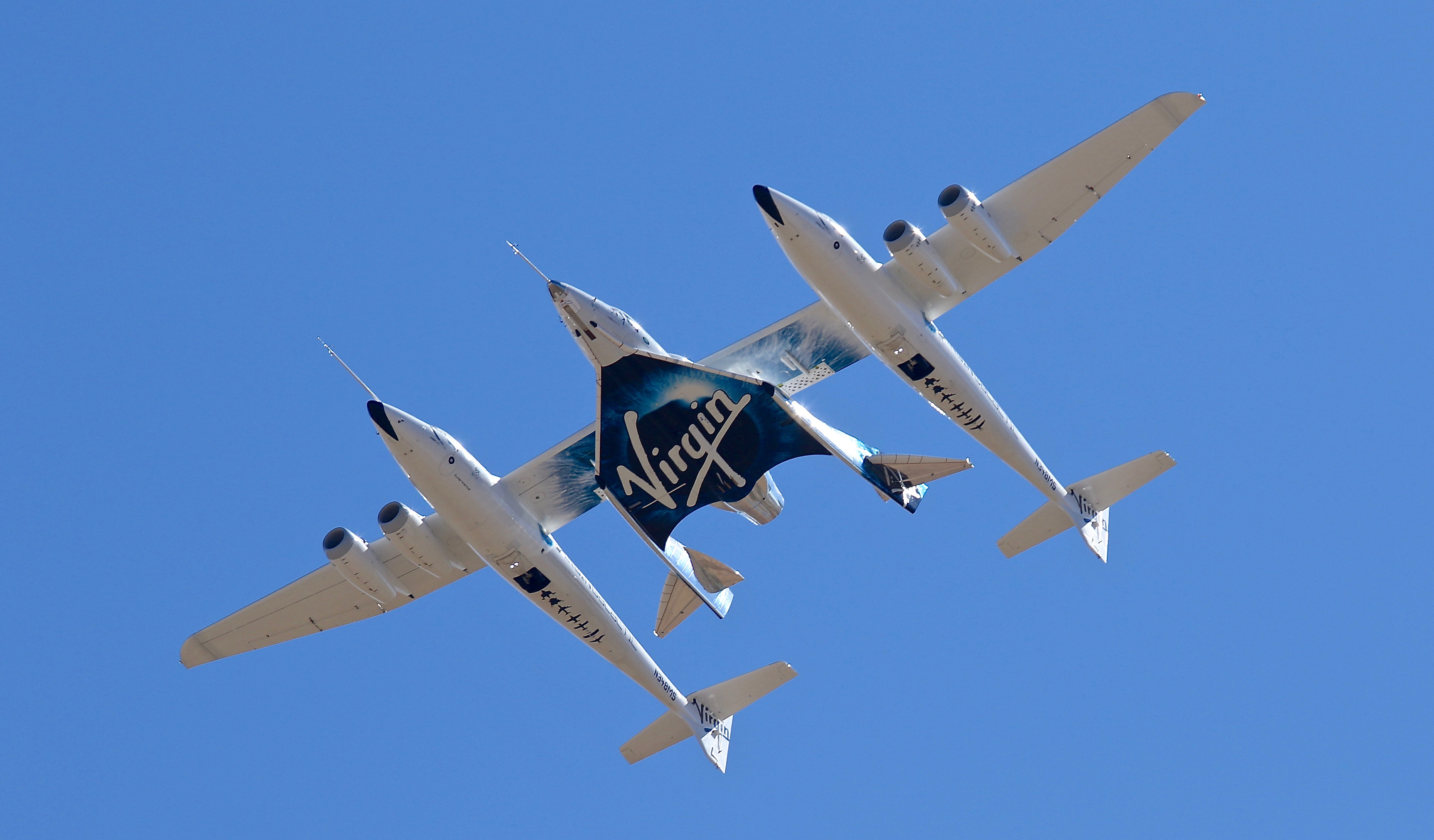 Virgin Galactic's spaceship VSS Unity, tucked under the wing of its special carrier aircraft [File: Matt Hartman/AP]